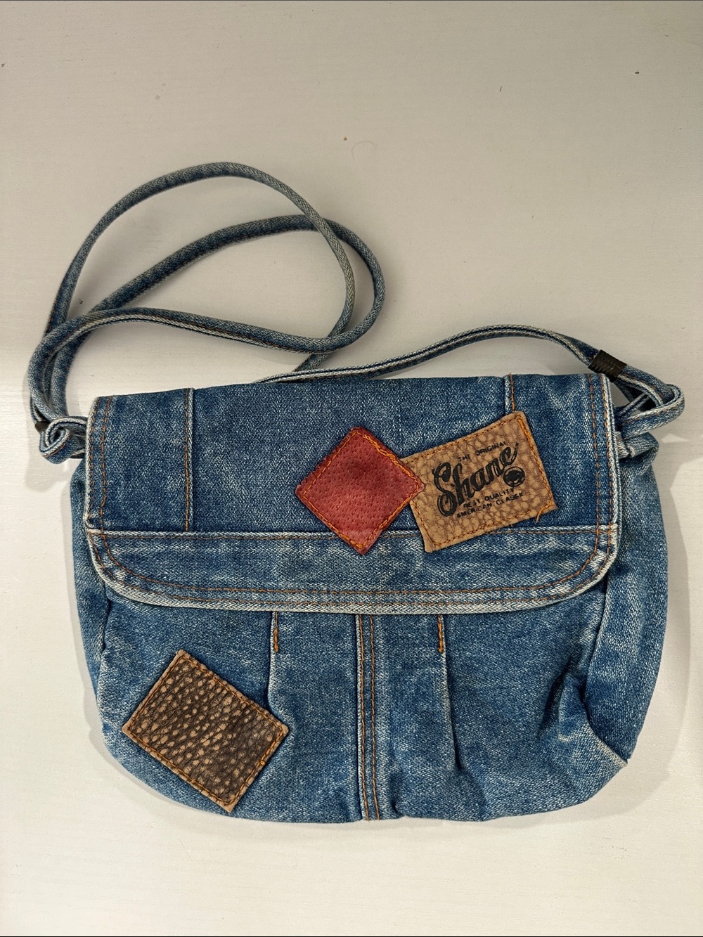 SHAN Denim Patchwork Crossbody Bag in Blue with Brown and Red Accents